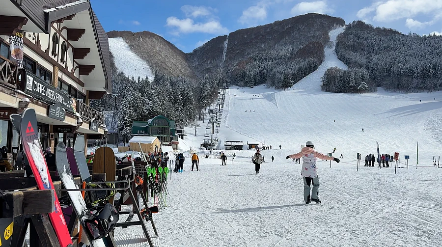 Skiing down the snowy slopes of Nozawa Onsen Ski Resort