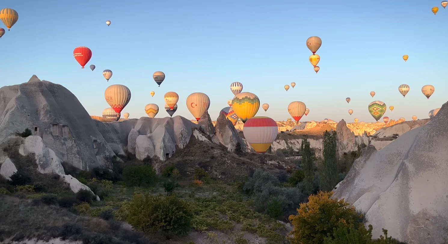 Hot air balloons flying at sunrise over Cappadocia